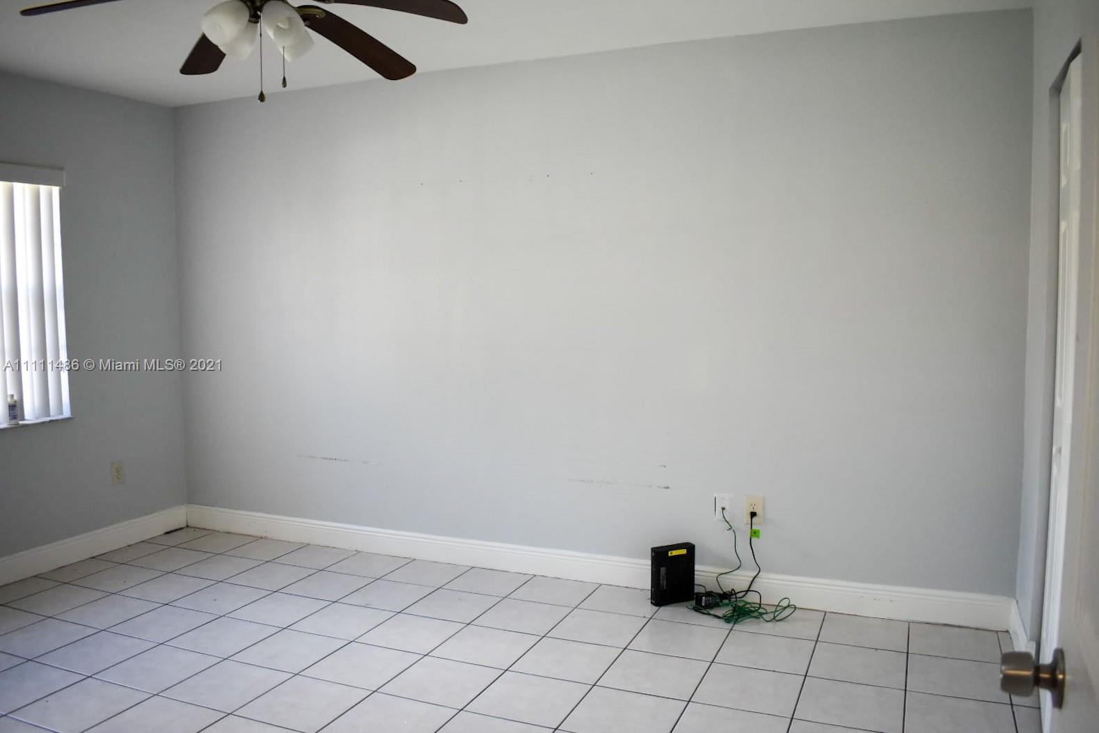 18280 Mediterranean Boulevard, Unit 43 Hialeah, FL 33015 - Photo 17 of 28 a room with a window