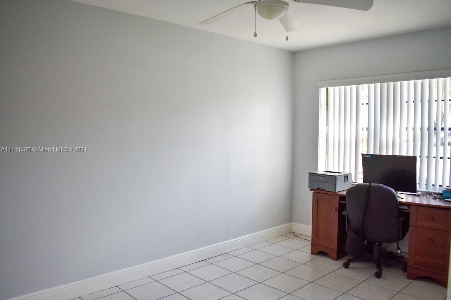 18280 Mediterranean Boulevard, Unit 43 Hialeah, FL 33015 - Photo 21 of 28 a view of a workspace with furniture and a window