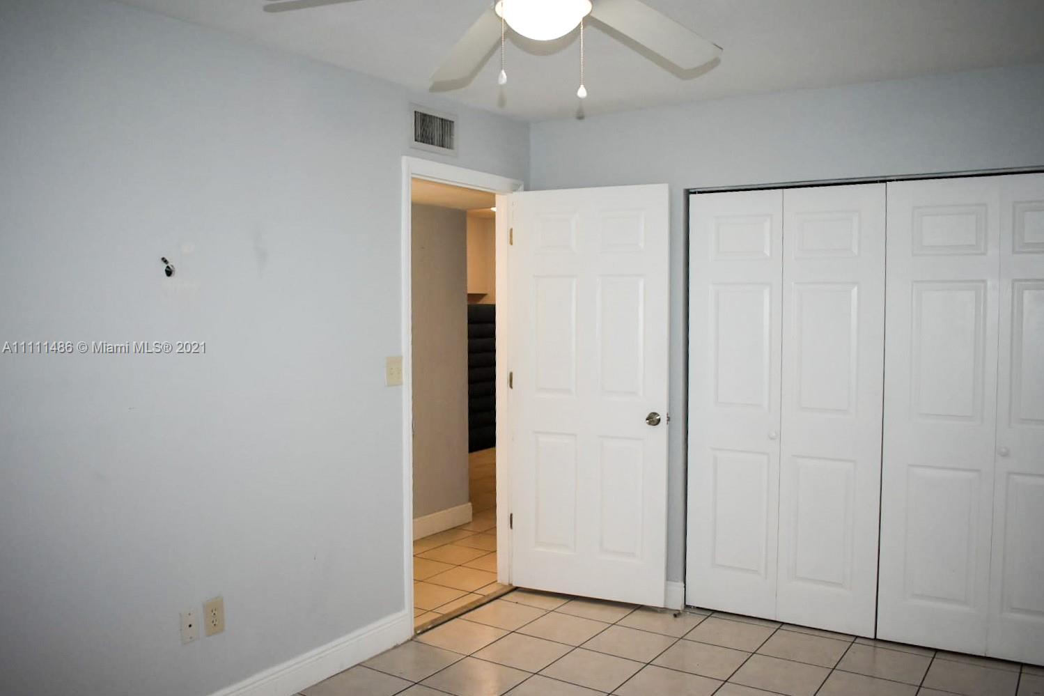 18280 Mediterranean Boulevard, Unit 43 Hialeah, FL 33015 - Photo 23 of 28 a view of a hallway with closet area