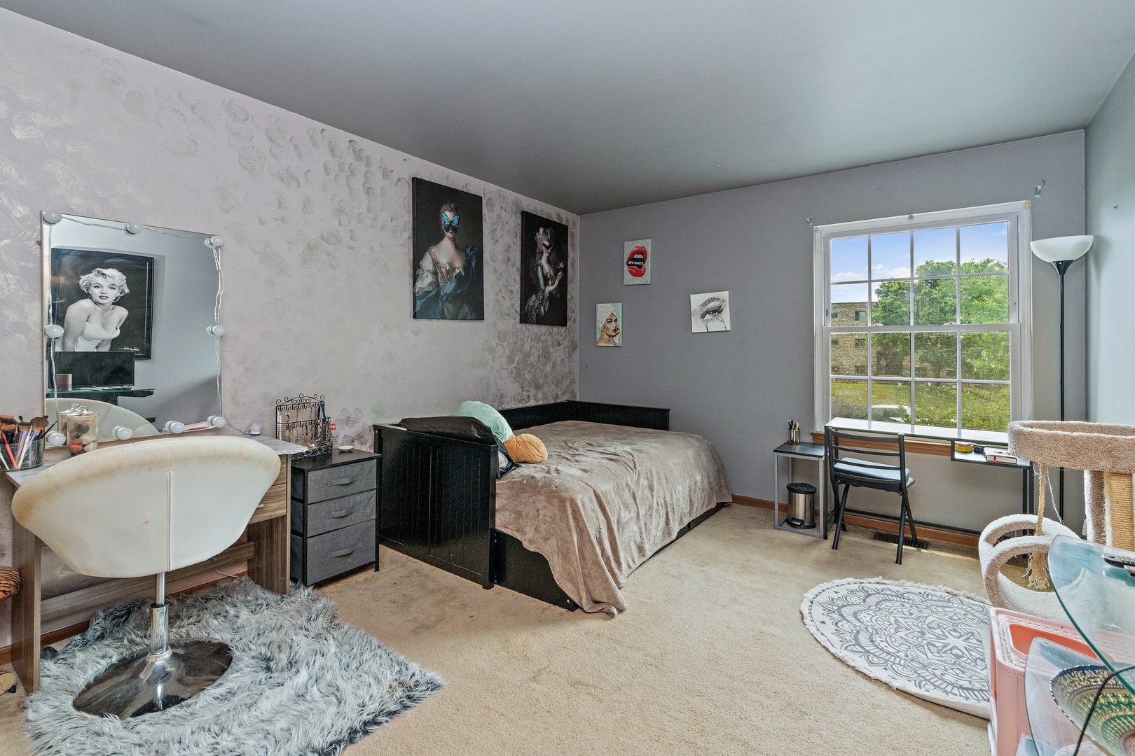 709 Meadows Boulevard Addison, IL 60101 - Photo 12 of 22 a bedroom with a bed a chair and a dresser next to a window