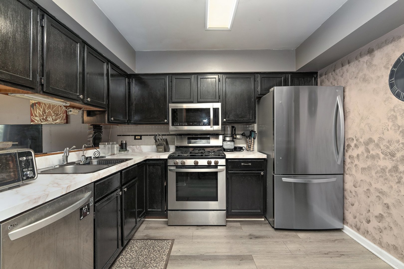 709 Meadows Boulevard Addison, IL 60101 - Photo 5 of 22 a kitchen with stainless steel appliances granite countertop a refrigerator stove and sink