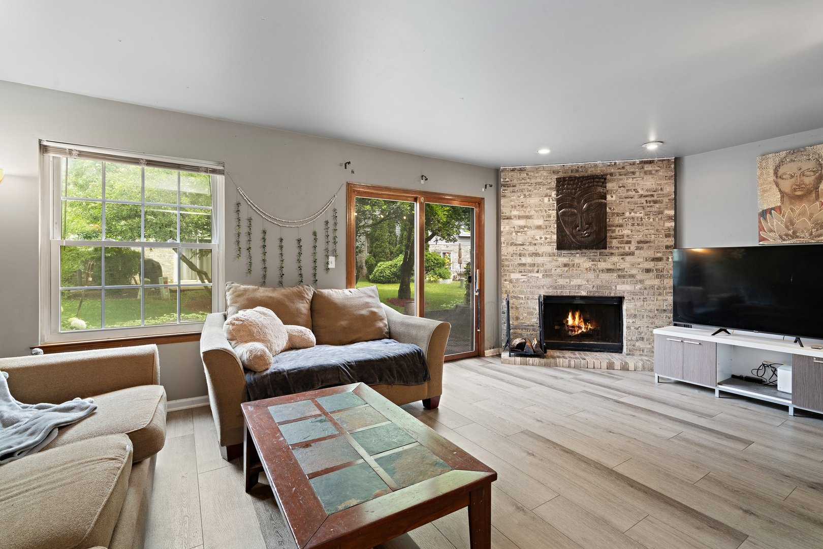 709 Meadows Boulevard Addison, IL 60101 - Photo 7 of 22 a living room with furniture a flat screen tv and a fireplace