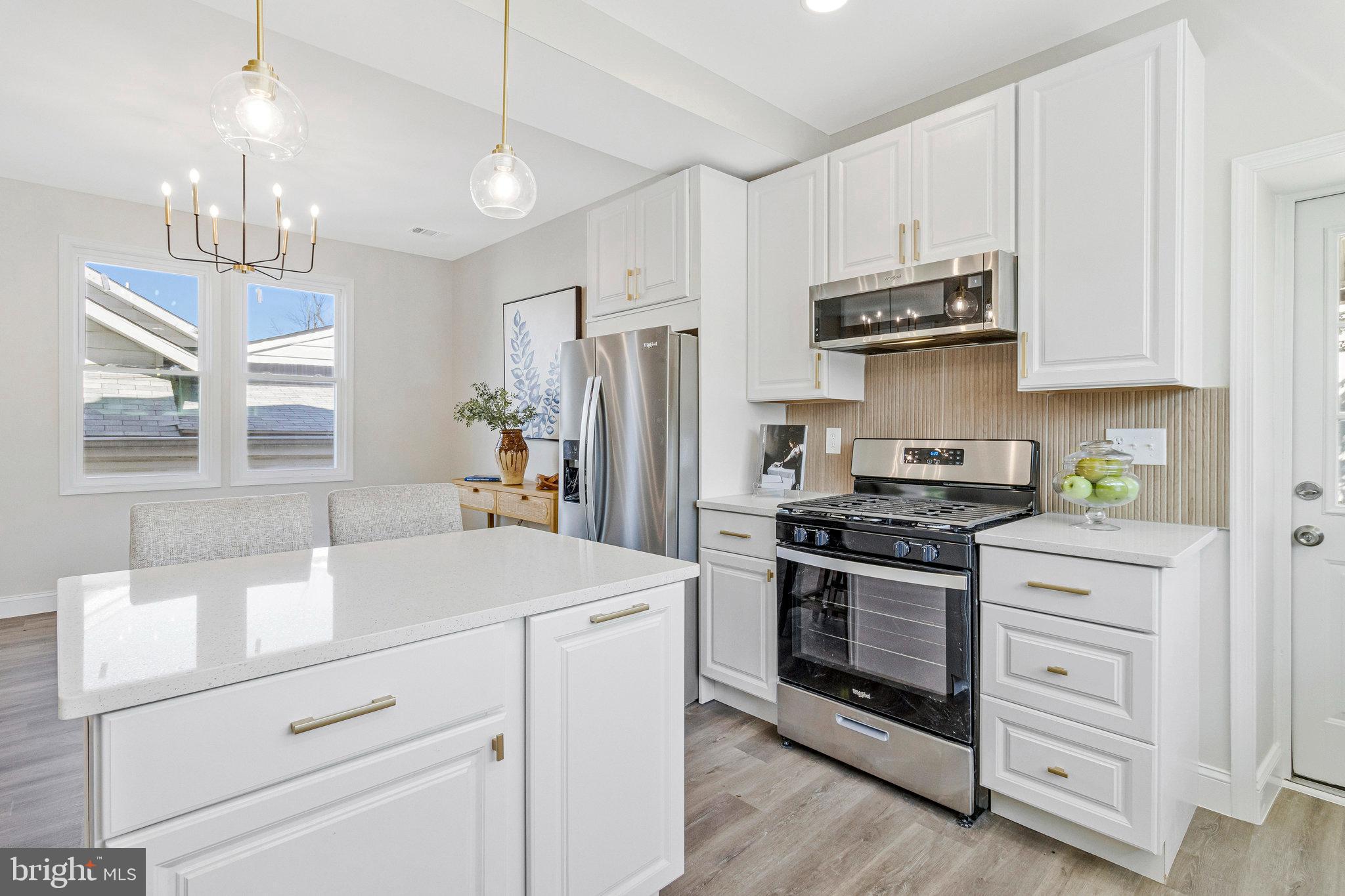 2140 32nd Street Southeast Washington, DC 20020 - Photo 19 of 50 a kitchen with white cabinets and stainless steel appliances