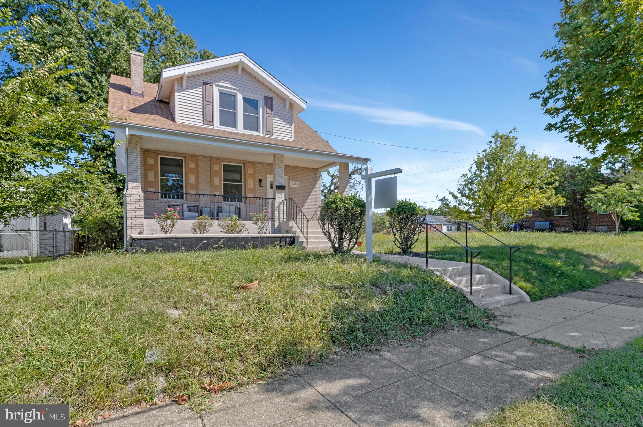 2140 32nd Street Southeast Washington, DC 20020 - Photo 2 of 50 a front view of a house with garden