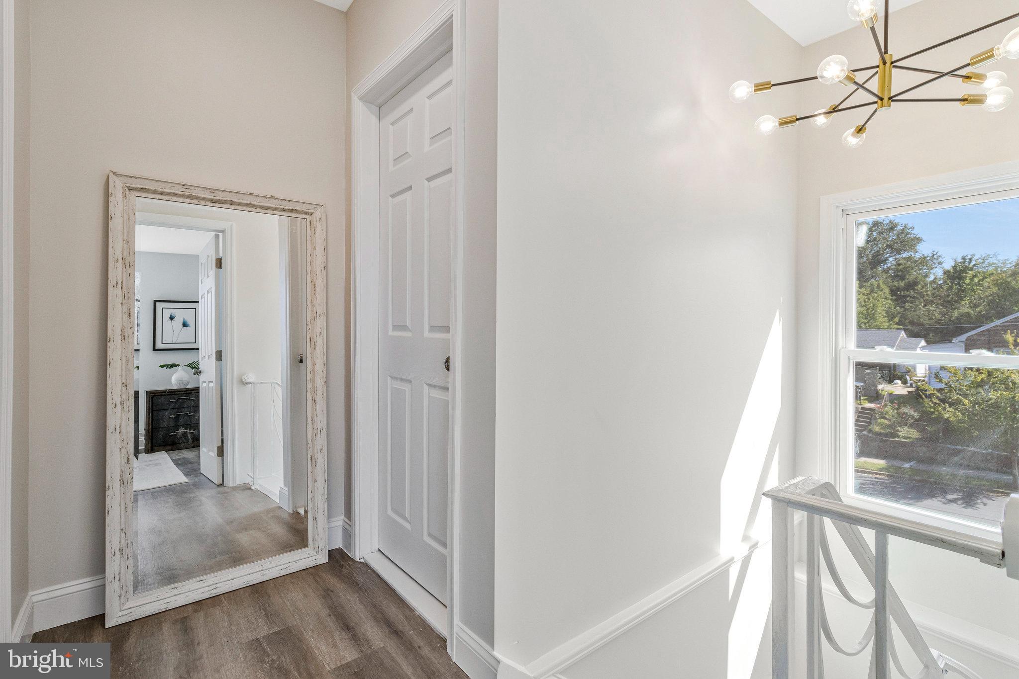 2140 32nd Street Southeast Washington, DC 20020 - Photo 23 of 50 a view of a hallway with wooden floor and a livingroom
