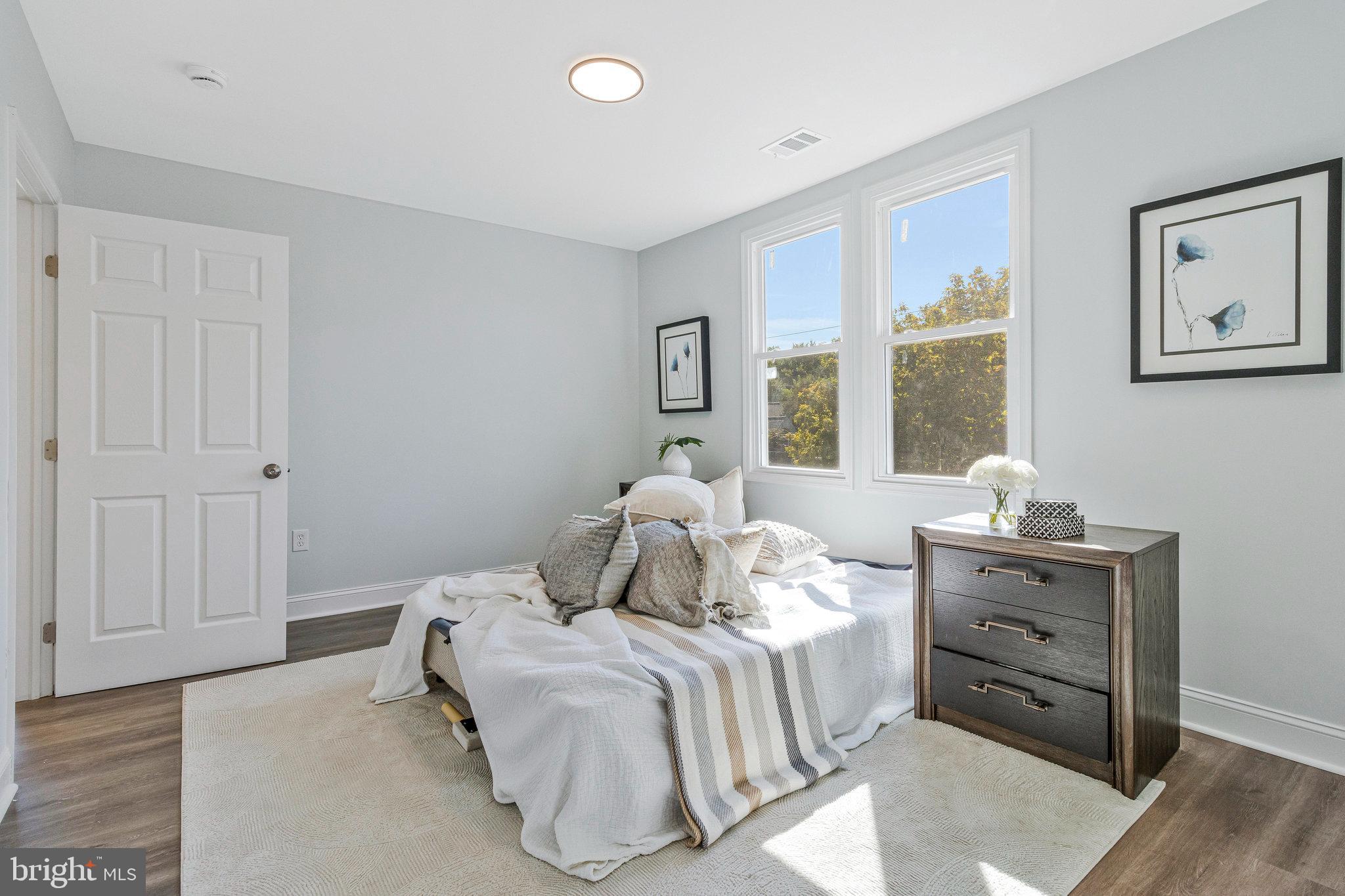 2140 32nd Street Southeast Washington, DC 20020 - Photo 25 of 50 a bedroom with a bed and wooden floor