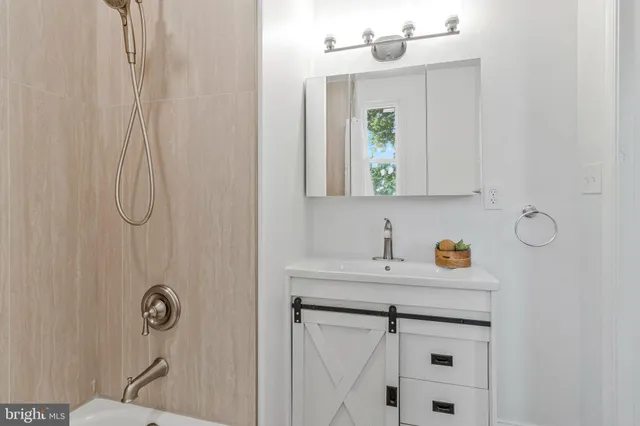 a bathroom with a sink vanity and mirror