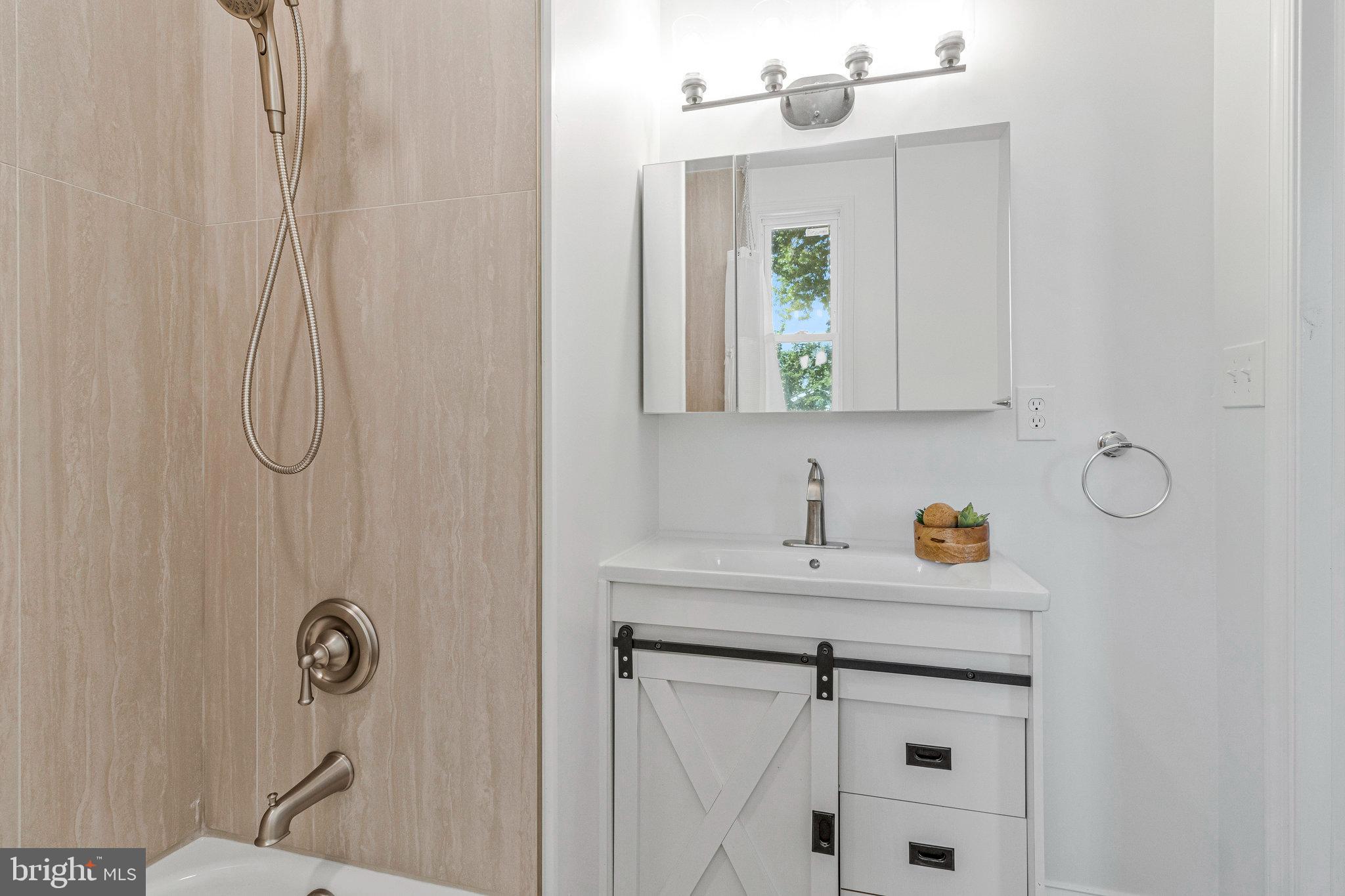 2140 32nd Street Southeast Washington, DC 20020 - Photo 30 of 50 a bathroom with a sink vanity and mirror