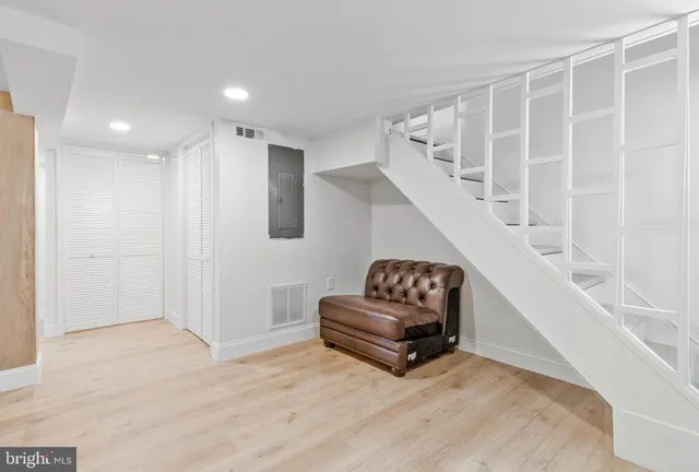 a living room with furniture and a ceiling fan