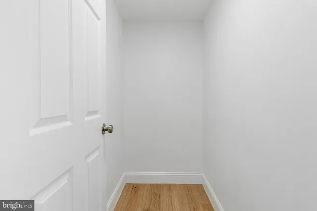 a view of a room with wooden floor lounge chair and windows