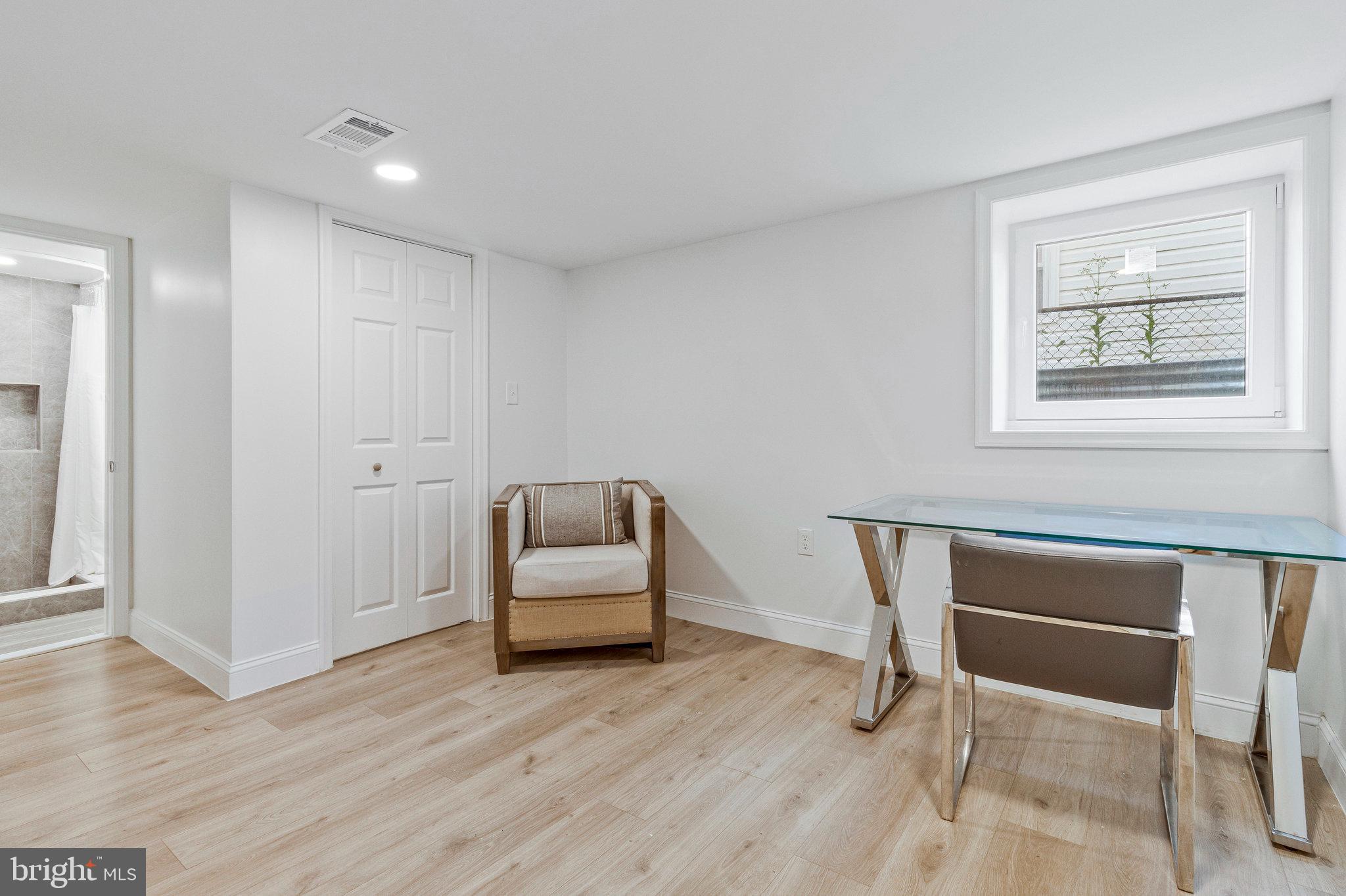 2140 32nd Street Southeast Washington, DC 20020 - Photo 40 of 50 a view of a room with wooden floor lounge chair and windows