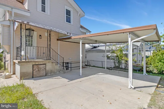 a view of a patio with table and chairs