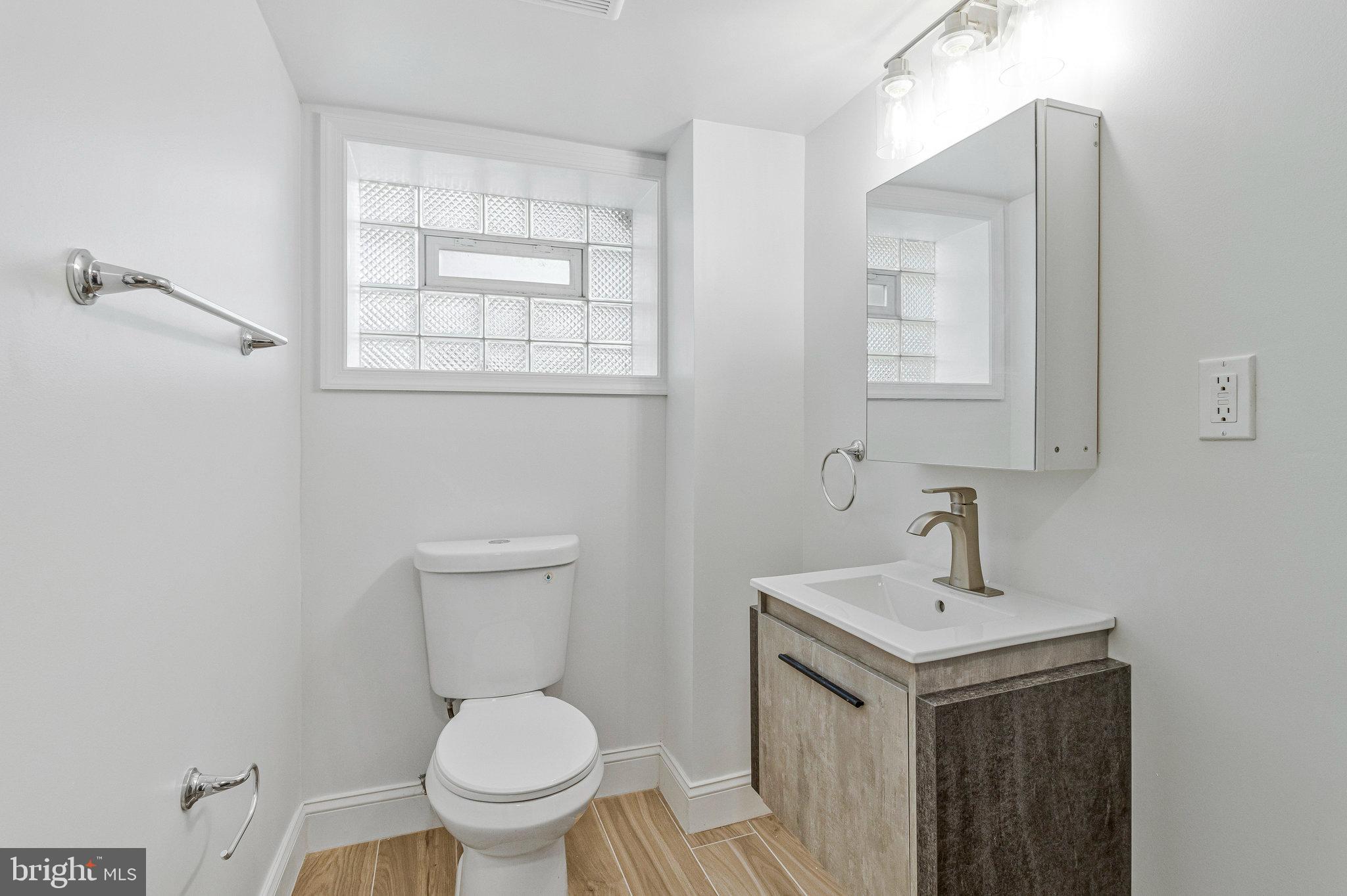 2140 32nd Street Southeast Washington, DC 20020 - Photo 42 of 50 a bathroom with a toilet a sink and mirror