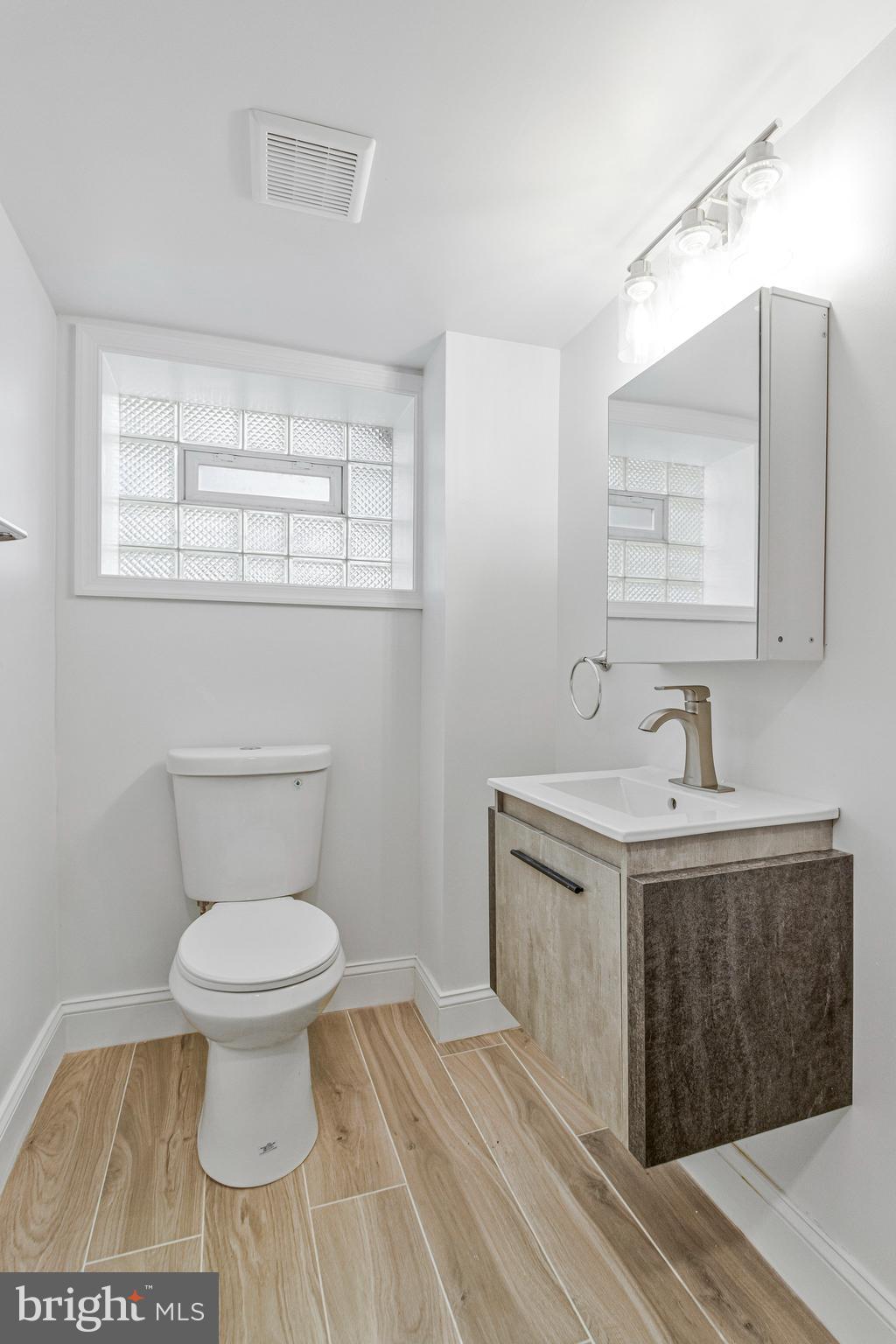 2140 32nd Street Southeast Washington, DC 20020 - Photo 43 of 50 a bathroom with a sink toilet and mirror