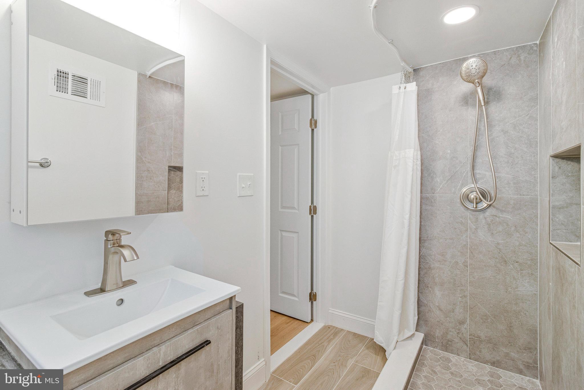 2140 32nd Street Southeast Washington, DC 20020 - Photo 44 of 50 a bathroom with a sink and a mirror