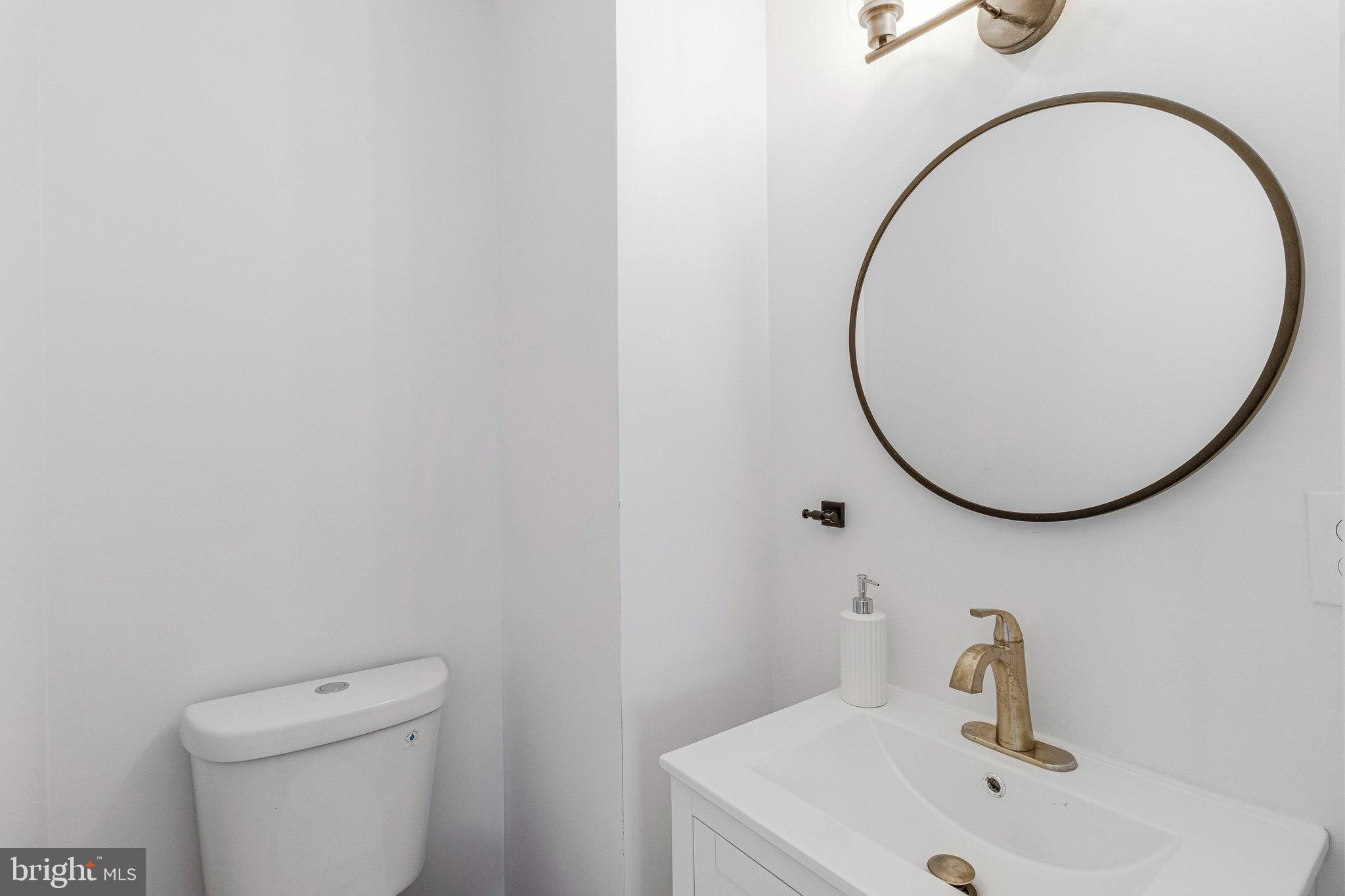 2140 32nd Street Southeast Washington, DC 20020 - Photo 7 of 50 a bathroom with a sink and a mirror