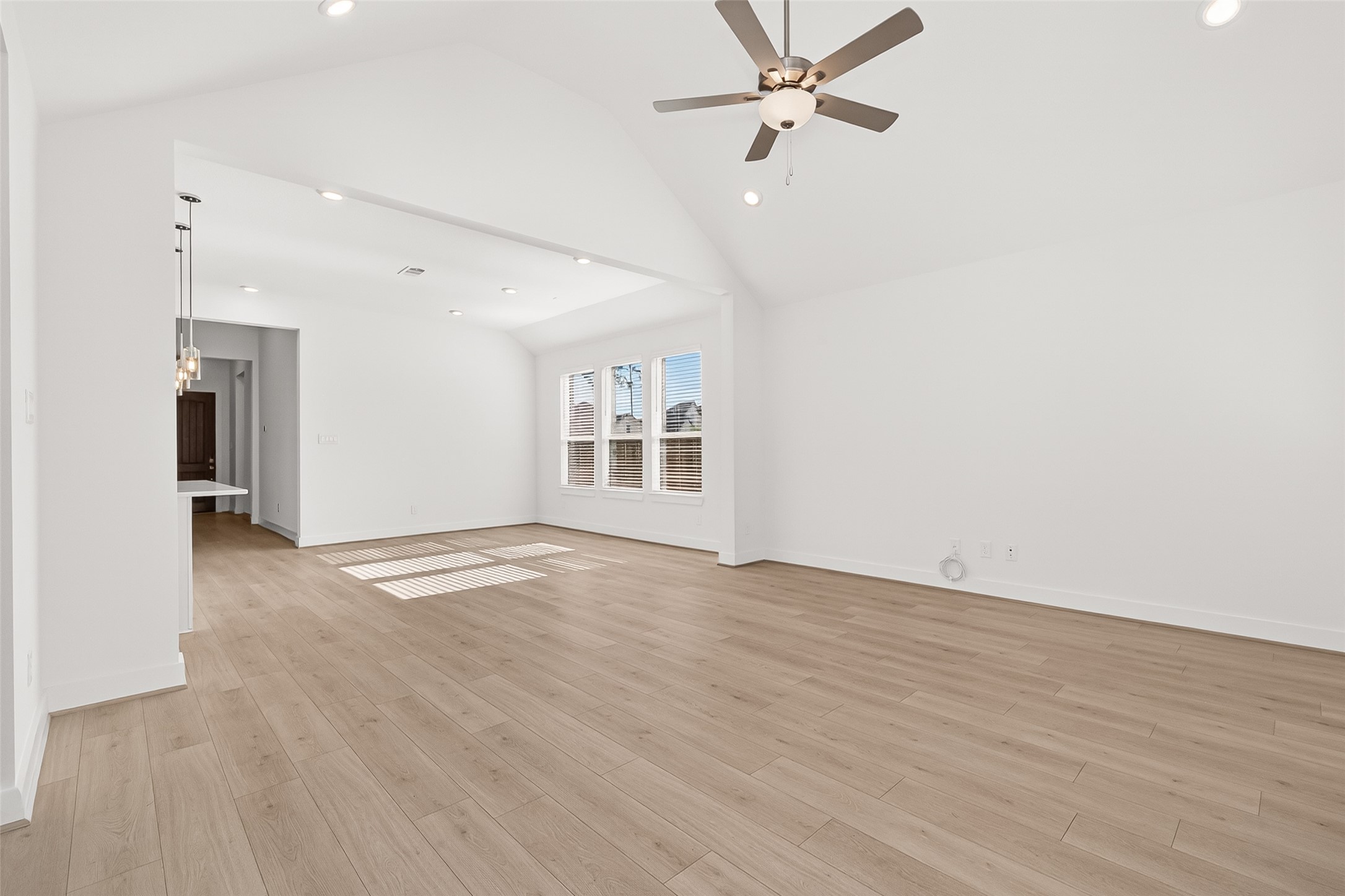 4916 Northern Wds Drive Spring, TX 77386 - Photo 11 of 44 an empty room with wooden floor ceiling fan and windows