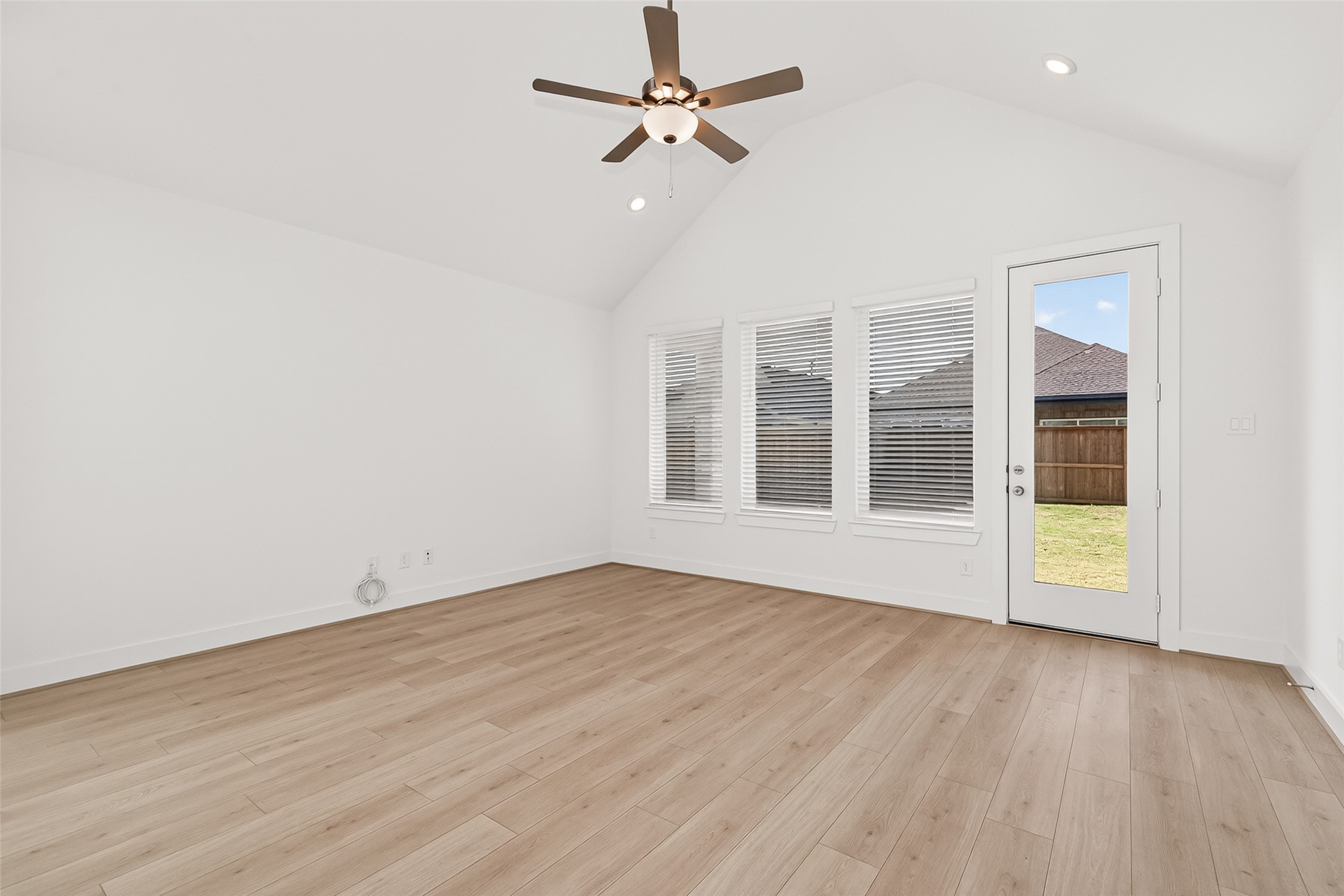 4916 Northern Wds Drive Spring, TX 77386 - Photo 8 of 44 an empty room with wooden floor fan and windows