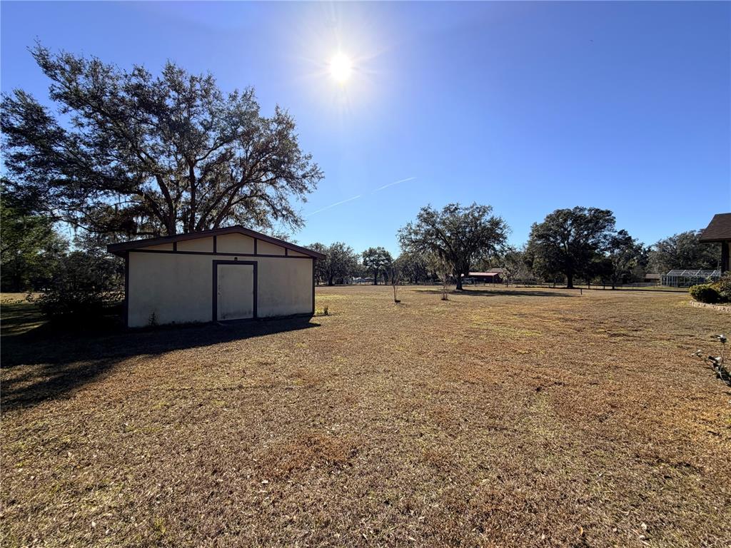 35324 Blanton Road Dade City, FL 33523 - Photo 12 of 49 a backyard of a house with lots of green space