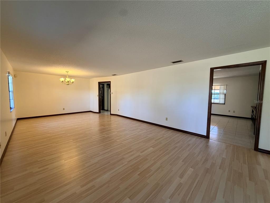 35324 Blanton Road Dade City, FL 33523 - Photo 20 of 49 a view of an empty room with wooden floor and a window