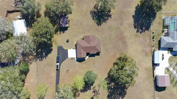 an aerial view of a house with outdoor space