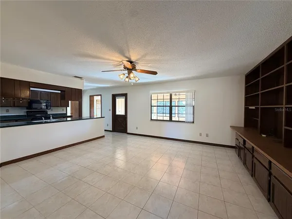 wooden floor in an empty room with a kitchen