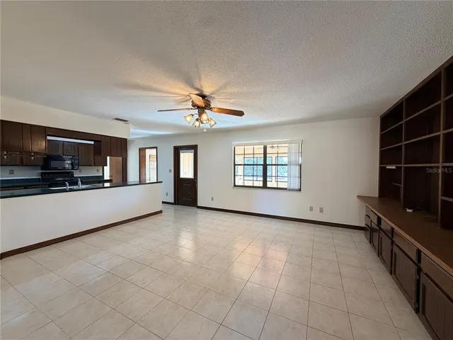 wooden floor in an empty room with a kitchen