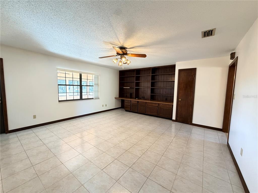 35324 Blanton Road Dade City, FL 33523 - Photo 23 of 49 an empty room with windows and chandelier fan