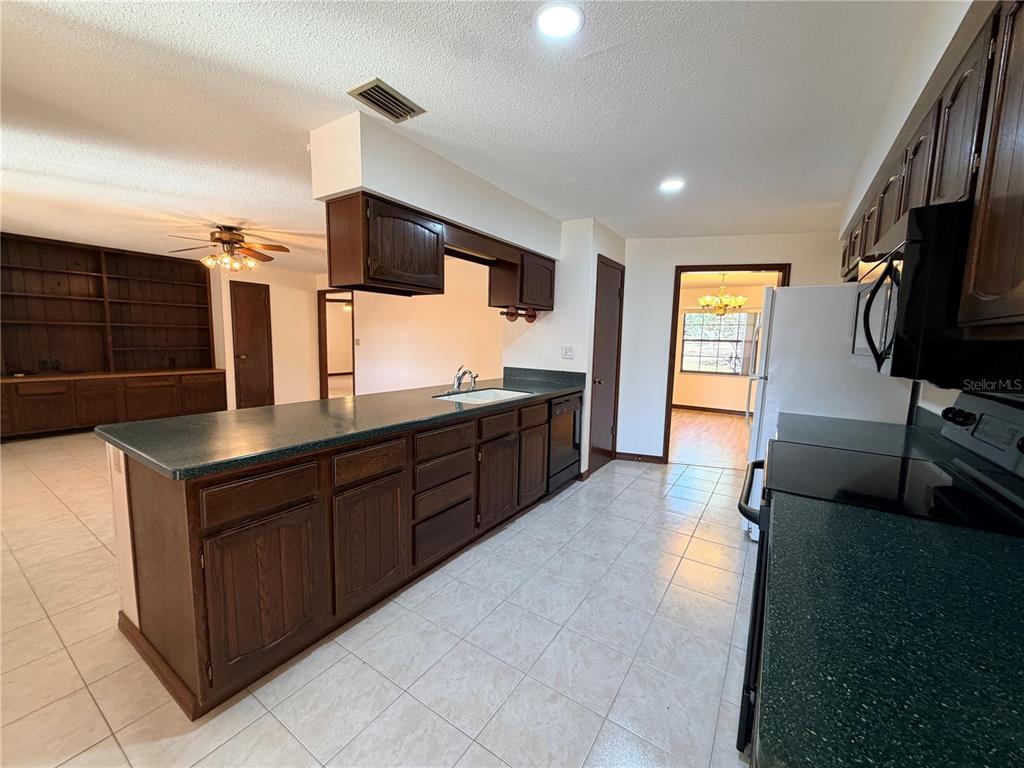35324 Blanton Road Dade City, FL 33523 - Photo 26 of 49 a kitchen with stainless steel appliances a sink and a microwave