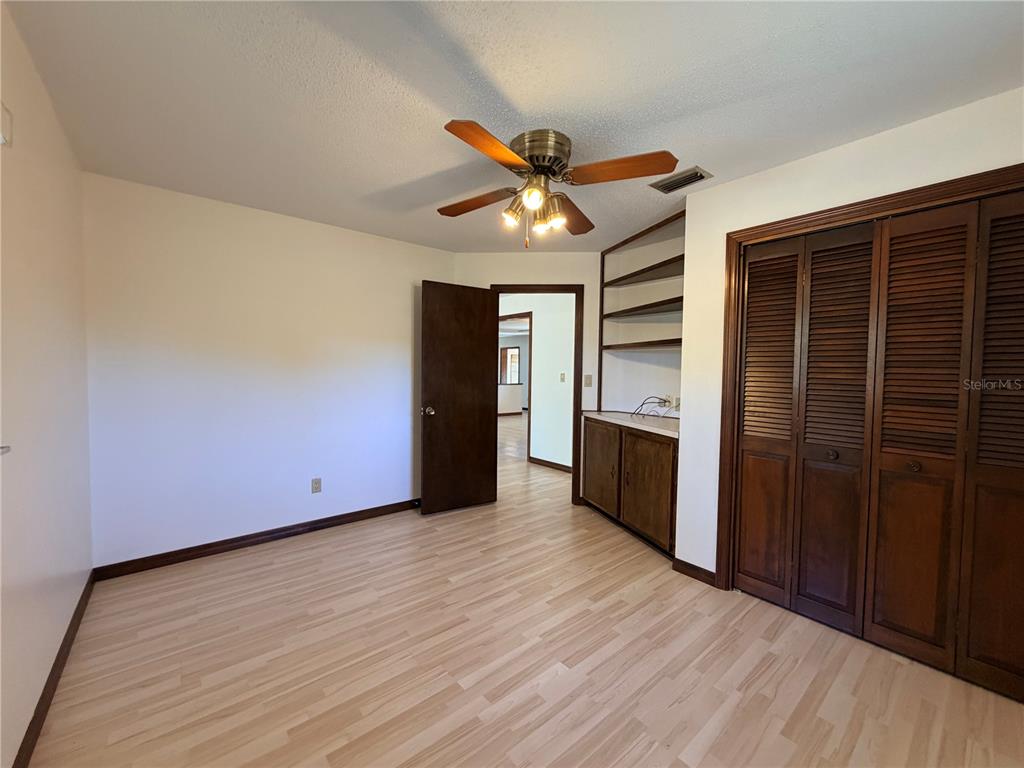 35324 Blanton Road Dade City, FL 33523 - Photo 41 of 49 wooden floor in an empty room with a kitchen