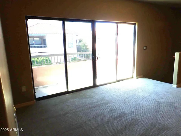 a view of a kitchen with cabinets and stainless steel appliances