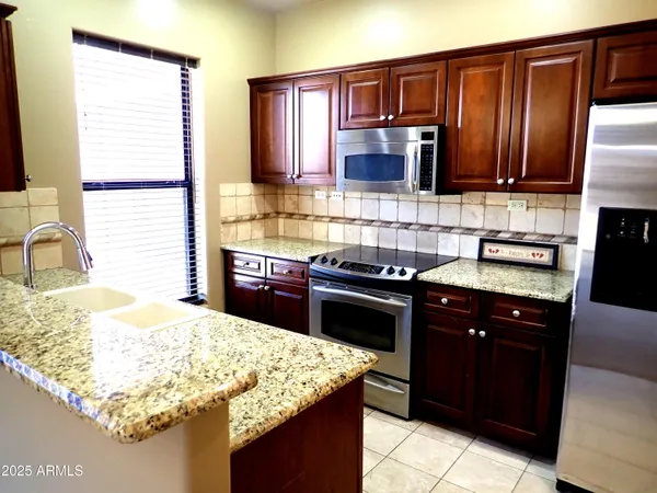a bathroom with a granite countertop sink and a bathtub