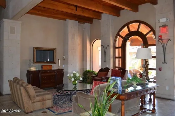 a living room filled with furniture and a floor to ceiling window