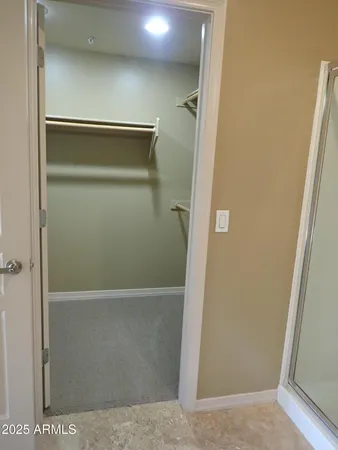 a bathroom with a shower and a glass door
