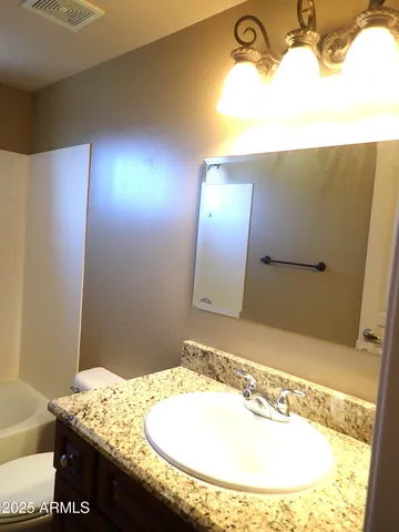 a bathroom with a sink and vanity