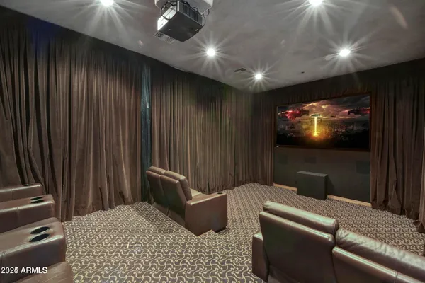 a living room with furniture and a projector screen