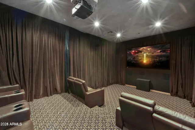 a living room with furniture and a projector screen