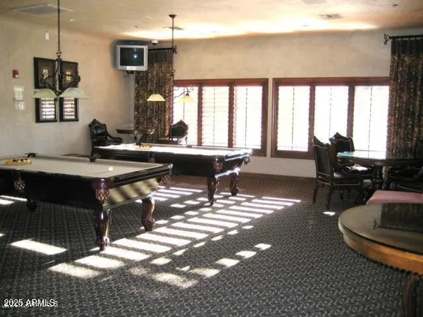 a living room with furniture a dining table and chairs with wooden floor