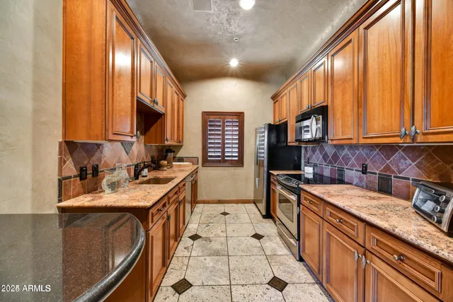 a kitchen with a sink stove and cabinets
