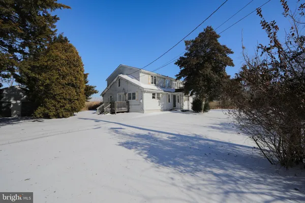 a view of a house with a snow on the road