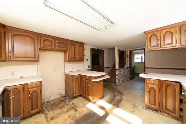 a view of a kitchen with fridge and wooden floor