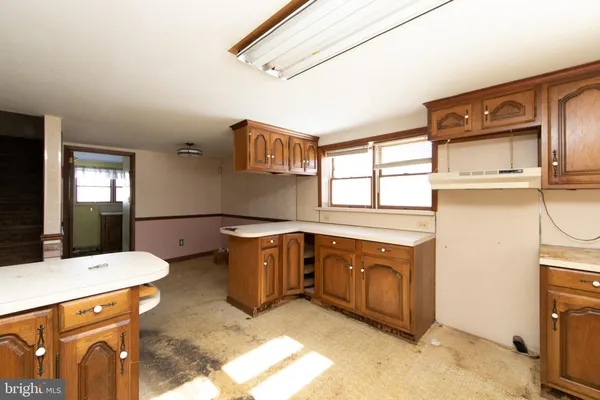 a spacious bathroom with a tub sink and mirror
