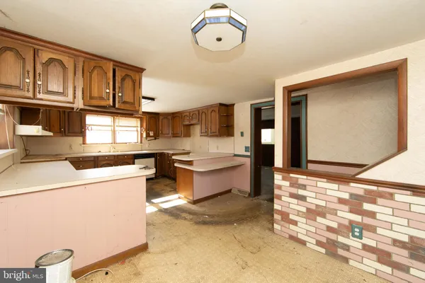 a large kitchen with a lot of cabinets and stainless steel appliances