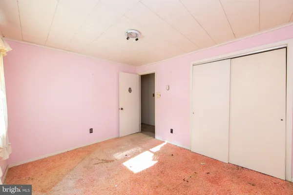 a view of a room with a ceiling fan