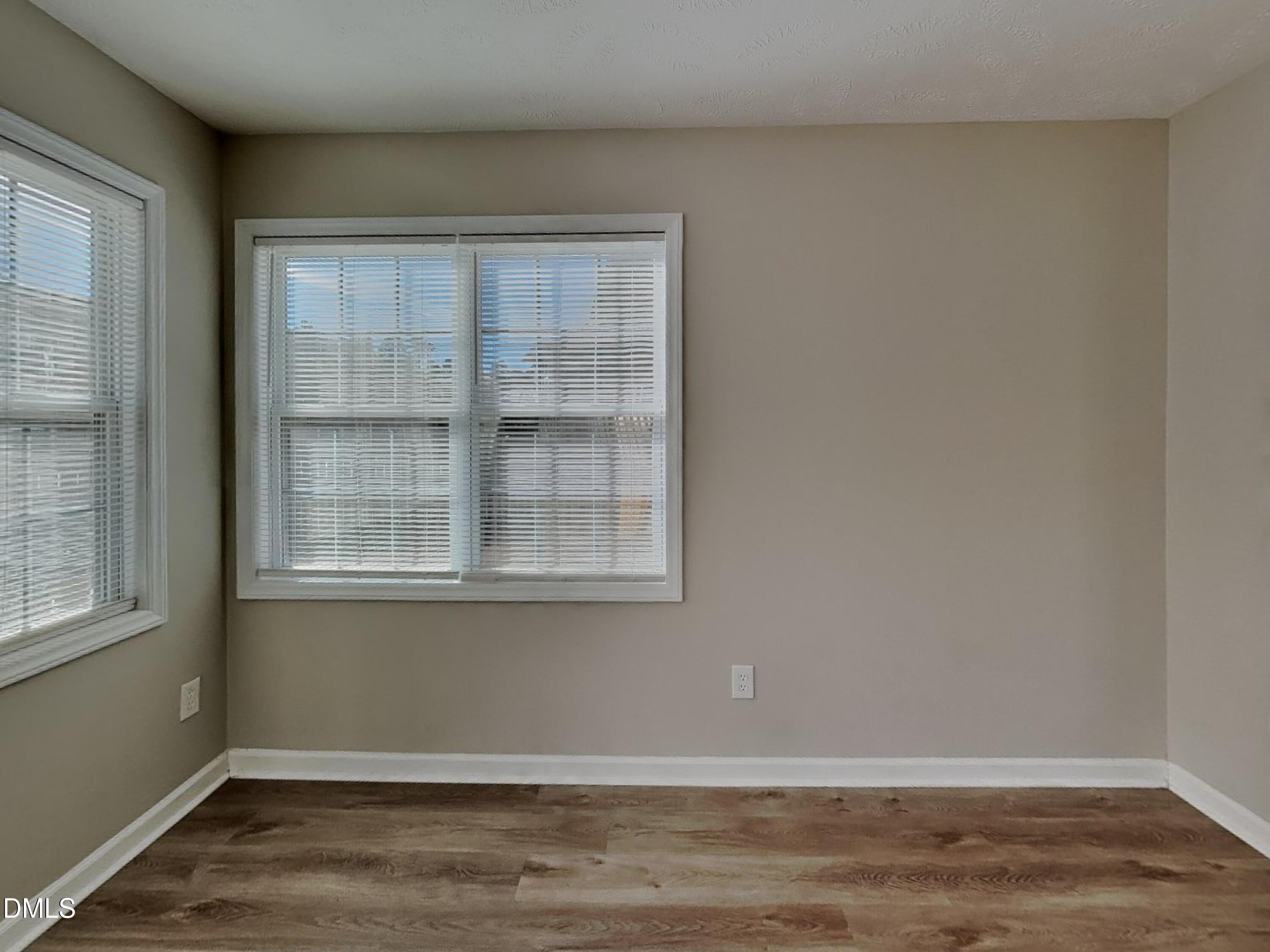 200 Lattimore Road Cameron, NC 28326 - Photo 4 of 21 an empty room with wooden floor and windows