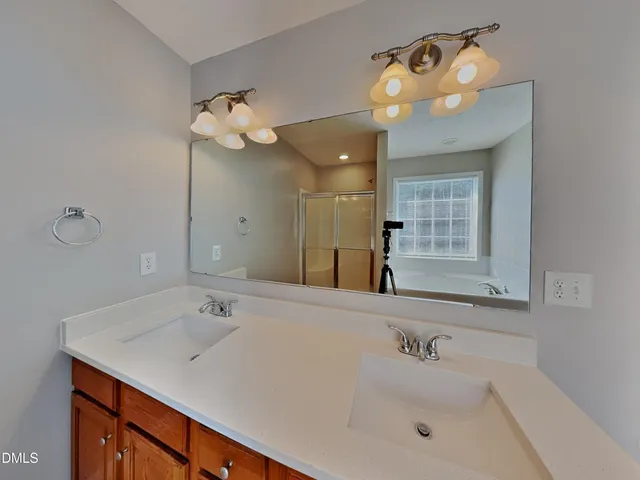 a bathroom with a sink a mirror and a light fixture