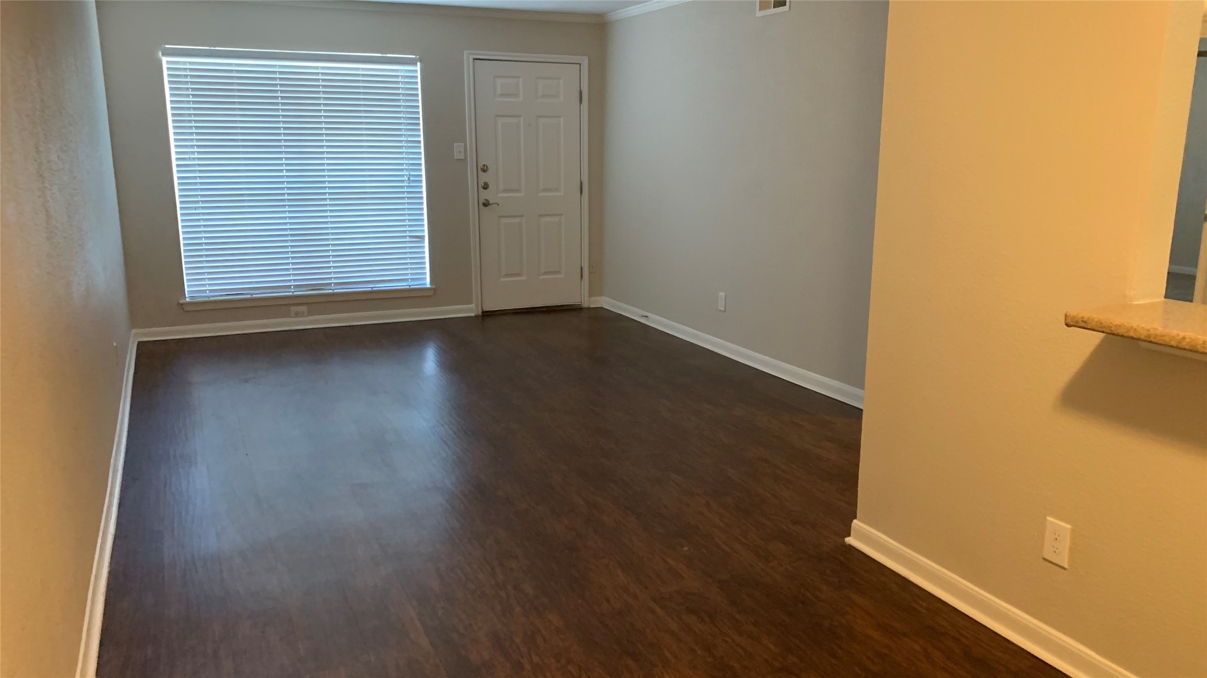 7315 Brompton Street, Unit 247A Houston, TX 77025 - Photo 4 of 13 an empty room with wooden floor and windows