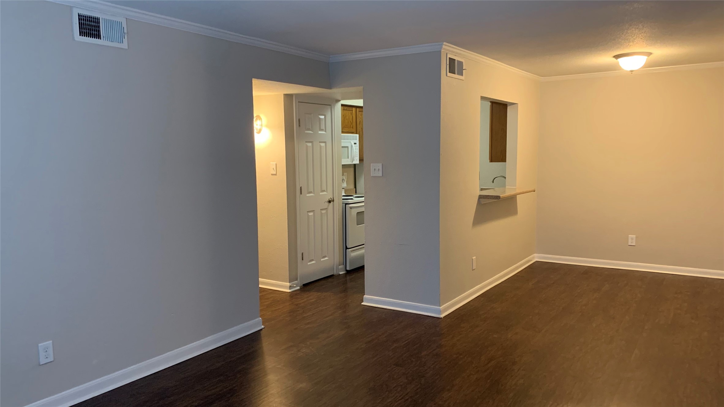 7315 Brompton Street, Unit 247A Houston, TX 77025 - Photo 5 of 13 an empty room with wooden floor and a window