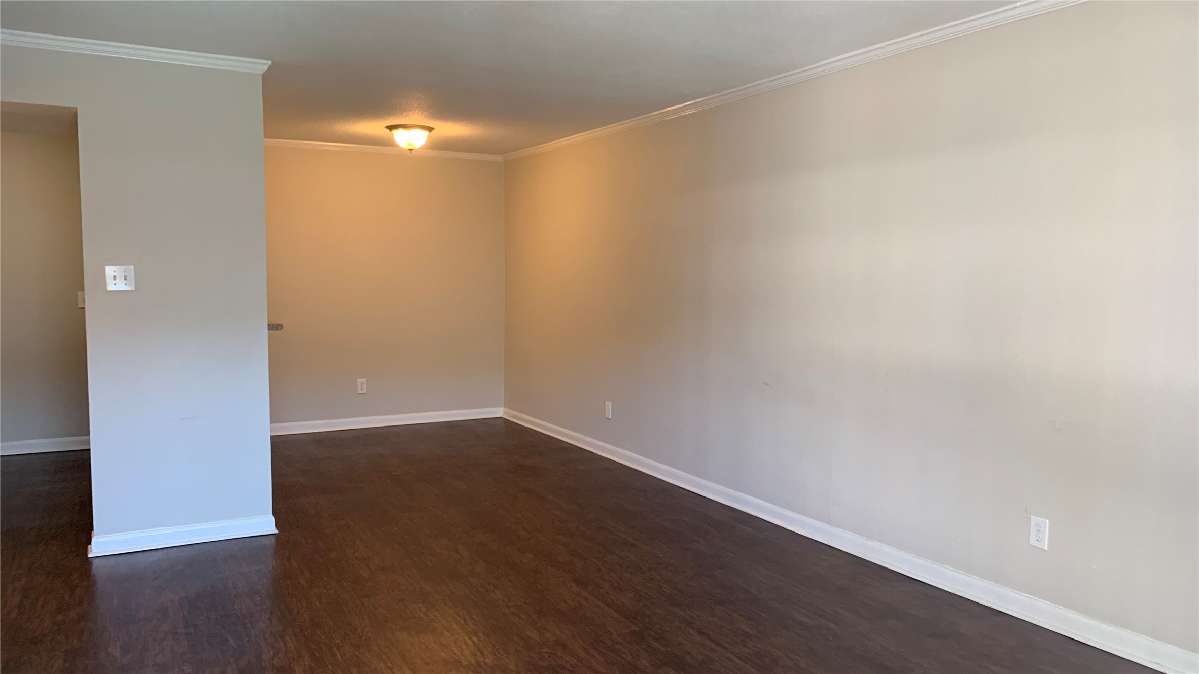 7315 Brompton Street, Unit 247A Houston, TX 77025 - Photo 6 of 13 a view of an empty room with wooden floor and a window