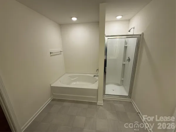 a bathroom with a tub and shower